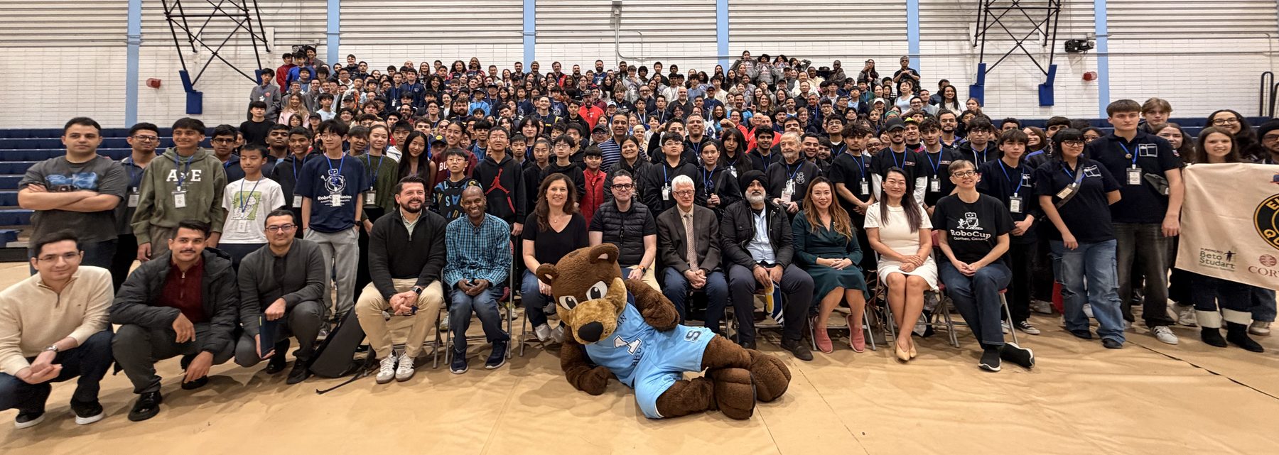 Several hundred competitors, mentors, volunteers and guests gathered in a college gym, the front row seated on chairs beside the Sheridan College bear mascot.